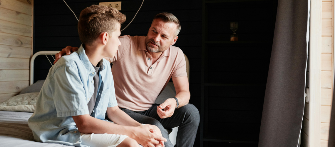 Caregiver offering calm support to a child, modeling how a safe adult listens and believes.