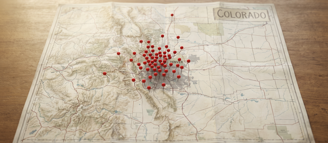  A map of Colorado with red pins clustered around the Denver metro area, symbolizing data on human trafficking case concentration 